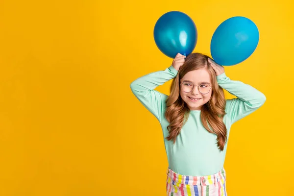 Photo of young cheerful girl happy positive smile hold balloons ears playful isolated over yellow color background — Stock Photo, Image