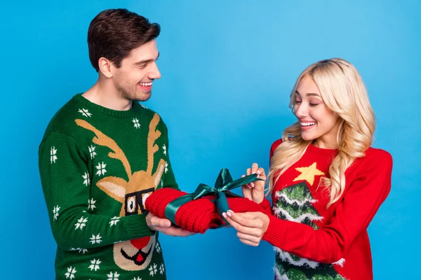 Photo of pretty sweet young people wear ugly ornament pullovers opening present smiling isolated blue color background — Stock Photo, Image