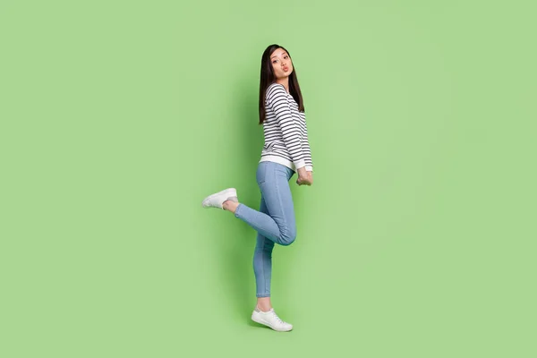 Full length body size profile side view of attractive coquettish thin girl posing having fun pout lips isolated over green color background — Zdjęcie stockowe