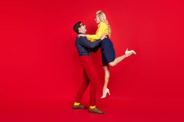 Full length body size view of attractive cheerful couple dancing twist rock rest isolated over bright red color background clipart