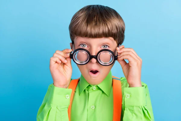 Portrait of attractive brainy amazed schoolboy nerd touching specs wow isolated over teal turquoise color background — Stock Photo, Image