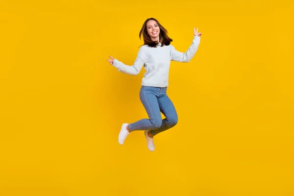 Full size photo of cheerful positive cool young woman jump up make v-signs sale isolated on yellow color background — Stock Photo, Image