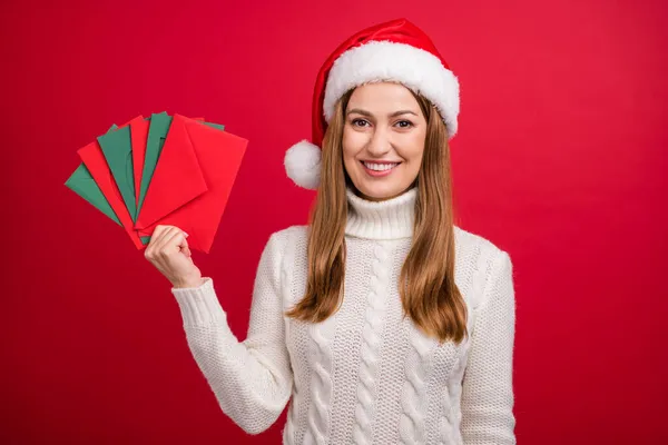 Portrait of attractive cheerful woman holding letter list festal event sale discount isolated over bright red color background — Stock Photo, Image