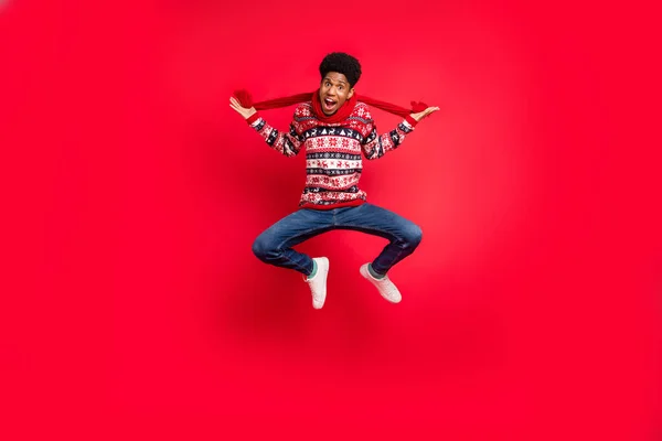 Full tělo fotografie mladého afro chlap šťastný pozitivní úsměv vyskočit šátek zimní dovolená izolované přes červené barvy pozadí — Stock fotografie