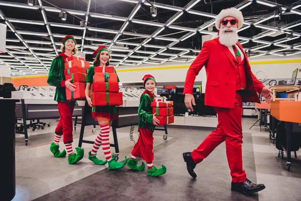 Full length body size view of attractive cheerful funky stylish group elfs buying pile giftboxes advent at store market indoors — Stock Photo, Image