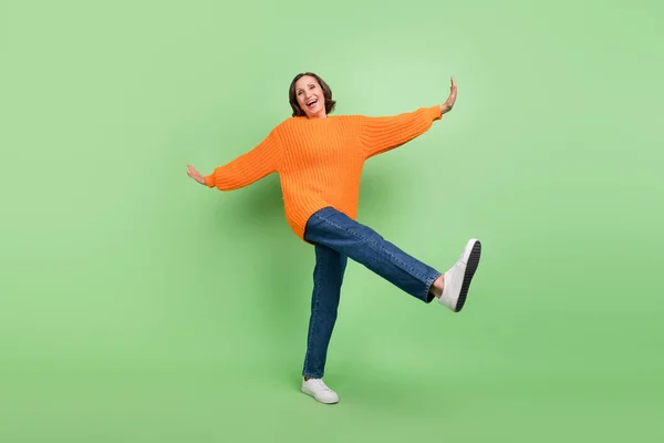 Full body profile side photo of excited senior woman have fun dance fooling isolated over green color background