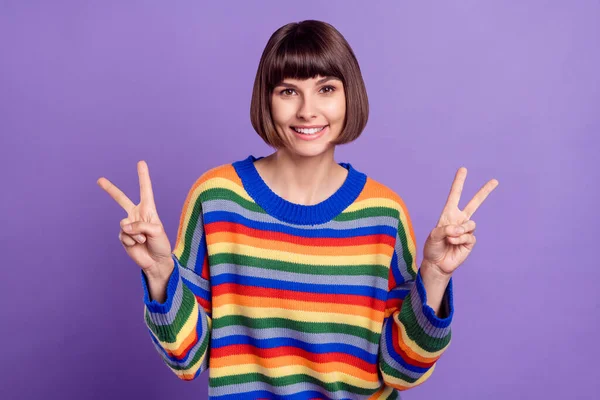 Fotografie přátelský okouzlující dáma bangs účes show v-sign nosit pruhované svetr izolované fialové barvy pozadí — Stock fotografie