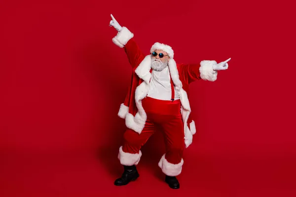 Photo of funky crazy carefree old man dance performance wear santa hat costume isolated red color background — Stock Photo, Image