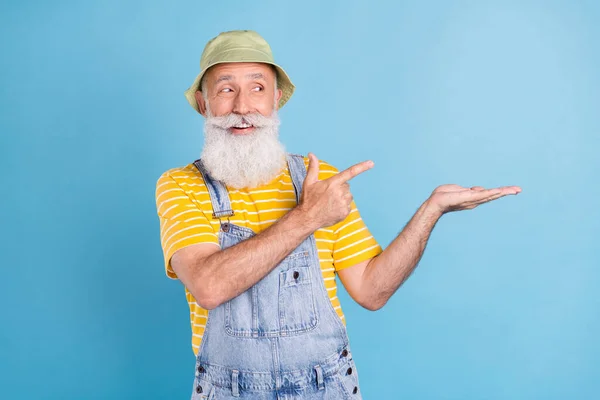 Fénykép idős férfi boldog pozitív mosoly jelzi ujj hirdetés tanácsot választás objektum elszigetelt kék szín háttér — Stock Fotó