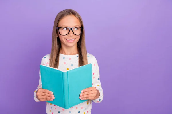 Foto de uma estudante pequena senhora olhar espaço vazio segurar especificações de desgaste do livro pontilhado pijama isolado cor roxa fundo — Fotografia de Stock