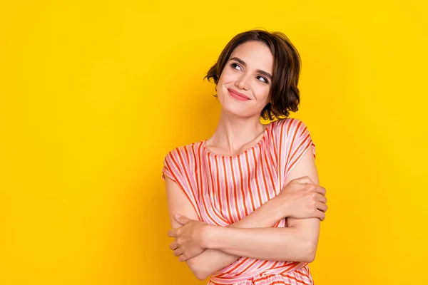 Portrait of attractive minded cheerful brown-haired girl fantasizing copy space isolated over bright yellow color background — Stock Photo, Image