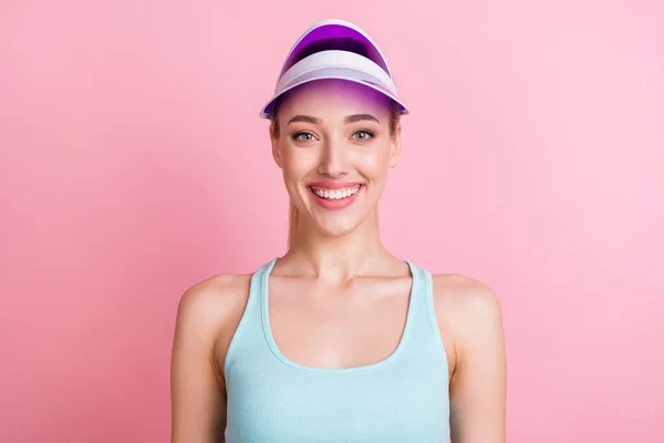 Portrait of attractive cheerful confident teenage girl wearing violet sunhat isolated over pink pastel color background — Stock Photo, Image