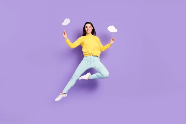 Full length body size view of attractive cheerful girl jumping holding copy space cards isolated over violet purple color background — Stock Photo, Image