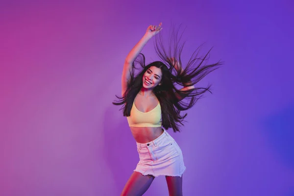 Portrait of attractive cheerful dreamy girl dancing rest relax isolated over vivid violet purple neon color background — Stock Photo, Image