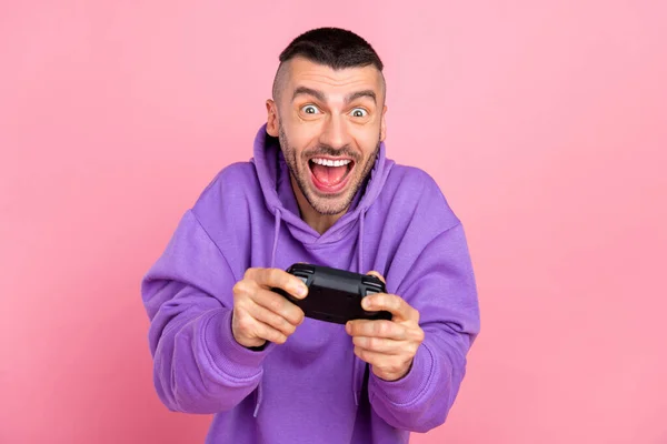 Photo of young addicted crazy man play console game joystick race isolated over pink color background — Stock Photo, Image