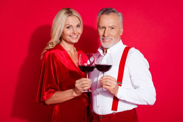Φωτογραφία του συνταξιούχου φίλη ρομαντικό ποτό κρασί επέτειο συναισθήματα εκδήλωση Χριστούγεννα απομονωθεί πάνω από το κόκκινο χρώμα φόντο — Φωτογραφία Αρχείου
