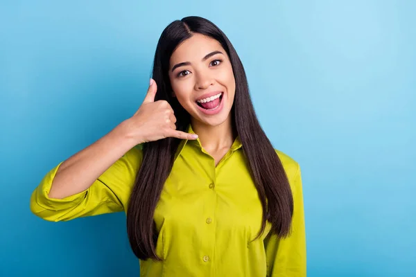 Foto de menina feliz sorriso positivo mostrar dedo chamada telefone sinal falar falar isolado sobre fundo de cor azul — Fotografia de Stock