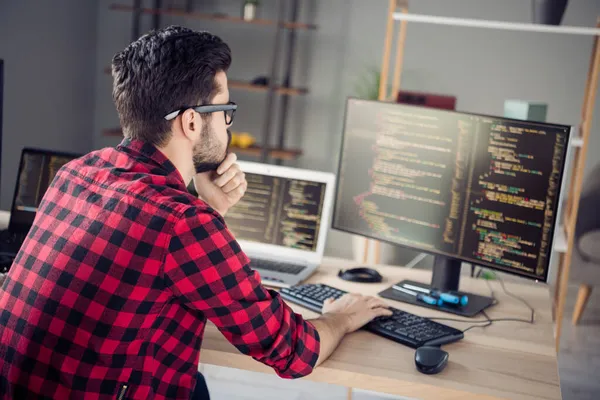 Profile side view portrait of attractive skilled focused guy writing html code css language php at work place station indoors — Stock Photo, Image