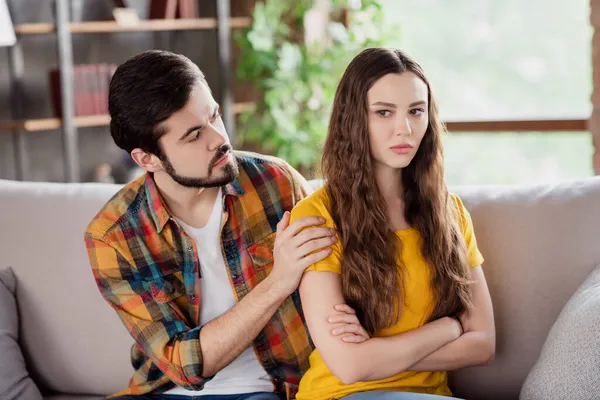 Photo of upset couple bearded man try comfort offended girlfriend wear casual clothes sit couch home indoors — Stock Photo, Image