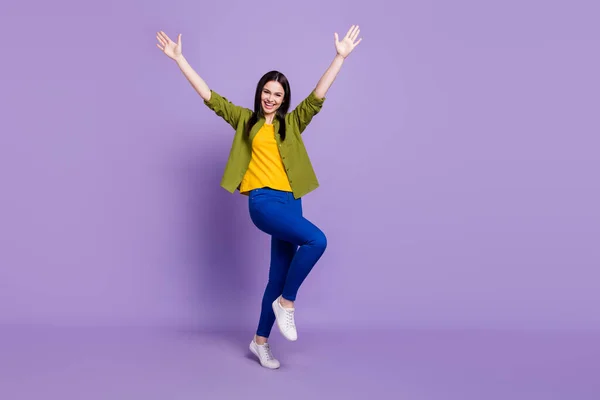 Full length photo of young cheerful girl happy positive smile have fun hands up isolated over purple color background — Stock Photo, Image