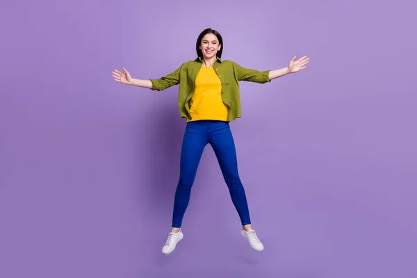 Foto em tamanho completo de menina alegre feliz sorriso positivo pular isolado sobre fundo de cor roxa — Fotografia de Stock