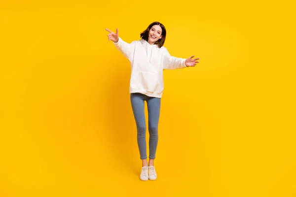 Full length body size view of attractive cheerful girl jumping hugging you having fun isolated over bright yellow color background — Stock Photo, Image