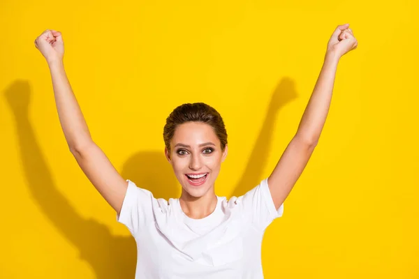 Photo of hooray brown short hairdo young lady hands up wear white t-shirt isolated on yellow color background — Stock Photo, Image