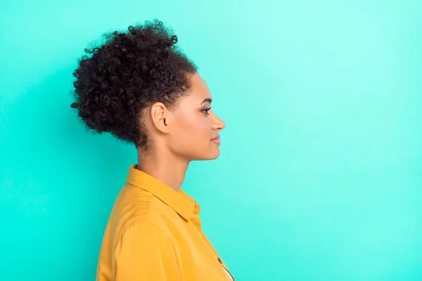 Photo of pretty charming lady wear yellow shirt looking empty space smiling isolated teal color background — Stock Photo, Image