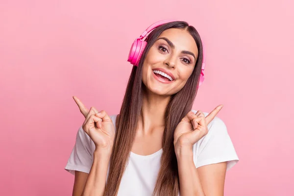 Photo of funny millennial brunette lady listen music wear white t-shirt isolated on pink color background — Stock Photo, Image