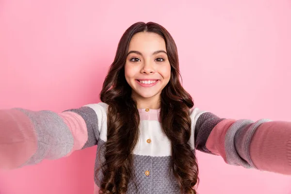 Photo of cheerful sweet small girl make selfie camera smile isolated on pastel pink color background — Stock Photo, Image