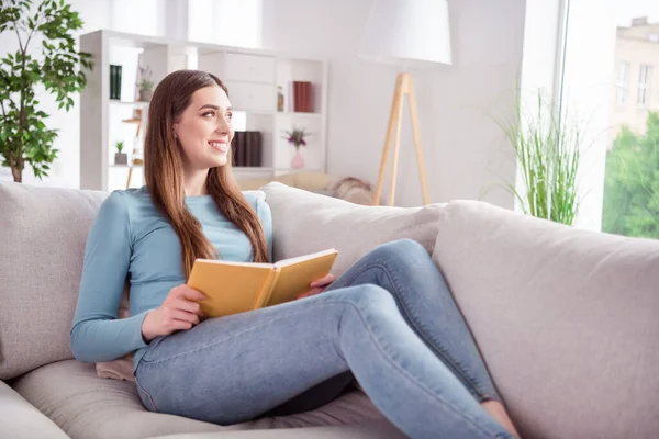 Profilo lato foto di giovane donna felice sorriso positivo sdraiato divano riposo leggere libro sogno al chiuso — Foto Stock