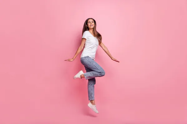 Vista completa del tamaño del cuerpo de la atractiva chica alegre saltando disfrutando de buen humor aislado sobre fondo de color pastel rosa —  Fotos de Stock