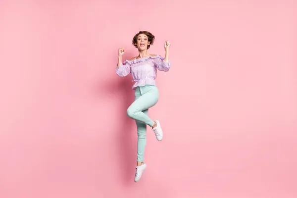 フルサイズ写真の若いです美しいです幸せな興奮良い気分の女の子ジャンプで勝利成功孤立したピンク色の背景 — ストック写真
