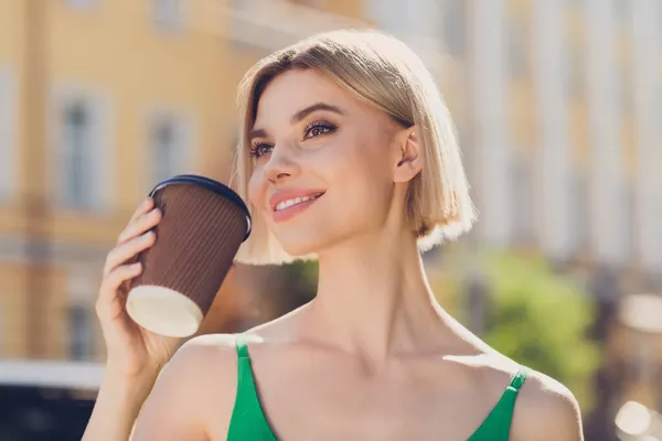 Photo of shiny sweet young lady wear green clothes walking drinking beverage smiling outside urban city street — Stock Photo, Image