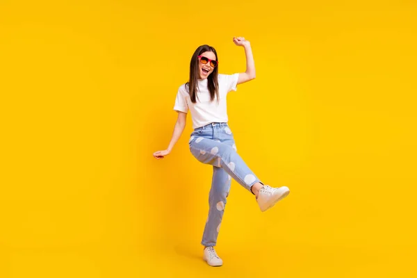 Full size photo of young excited girl happy positive smile have fun enjoy party dance isolated over yellow color background — Stock Photo, Image