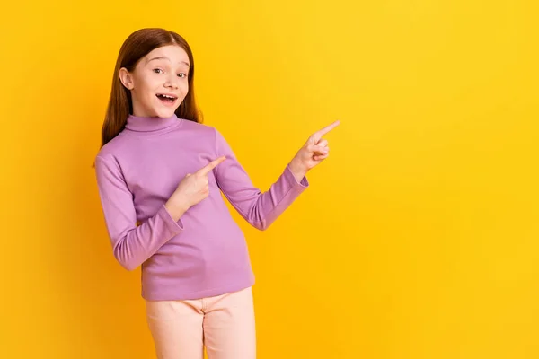 Photo of happy excited positive good mood little girl point fingers copyspace advertisement isolated on yellow color background — Stockfoto