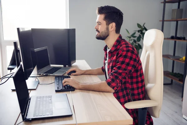 Profilseite Foto von glücklichen charmanten jungen Mann Schreibtisch schreiben Editor Computer drinnen im Büro — Stockfoto