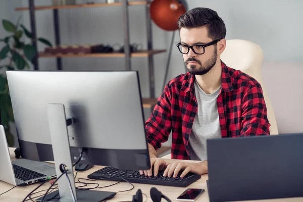 Portrait of attractive experienced focused guy writing creating code security database development at office work place station indoor — 图库照片