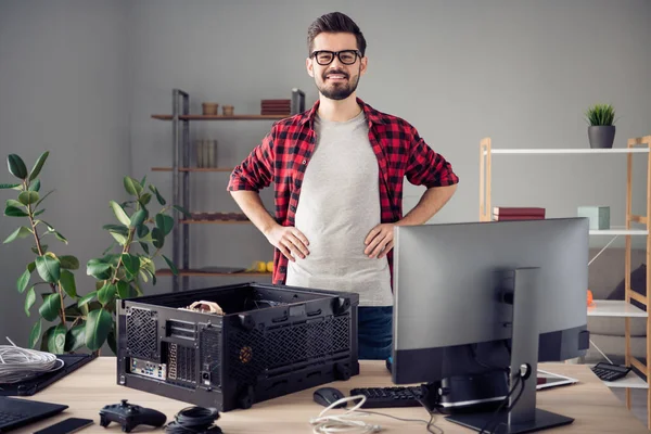 Portrait of attractive cheerful skilled trendy guy improving motherboard detail pc at studio office workplace workstation indoor — 图库照片