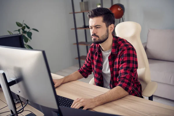 Photo of focused serious young man sit table work office business look screen computer inside indoors — Stock Photo, Image