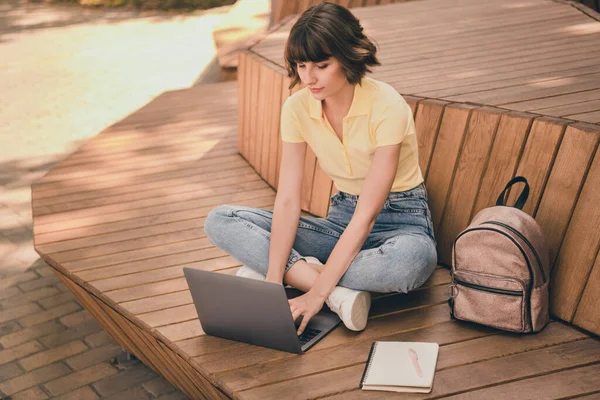 Full body photo of nice millennial brunette lady write laptop wear polo jeans shoes outside in city — Stock Photo, Image