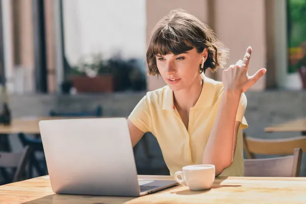 Portrait of attractive focused busy girl using laptop sitting at cafe discussing developing project start-up on fresh air outdoors — Stock Photo, Image