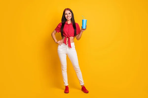 Full length photo of pretty cute young girl dressed red shirt holding blue soda glass isolated yellow color background — Stock Photo, Image