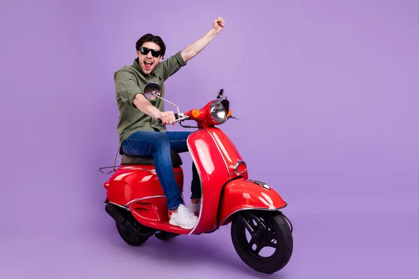 Full body photo of cheerful happy cheerful man wear sunglass motorbike winner isolated on violet color background