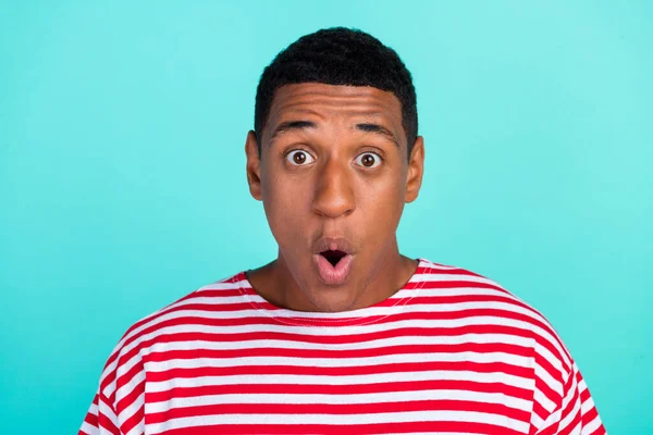Photo of funky shocked young man wear striped t-shirt big eyes isolated teal color background — Stock Photo, Image