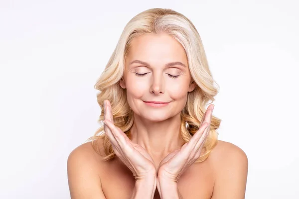 Portrait of attractive dreamy calm healthy grey-haired woman demonstrating pure skin isolated over white color background — Stock Photo, Image