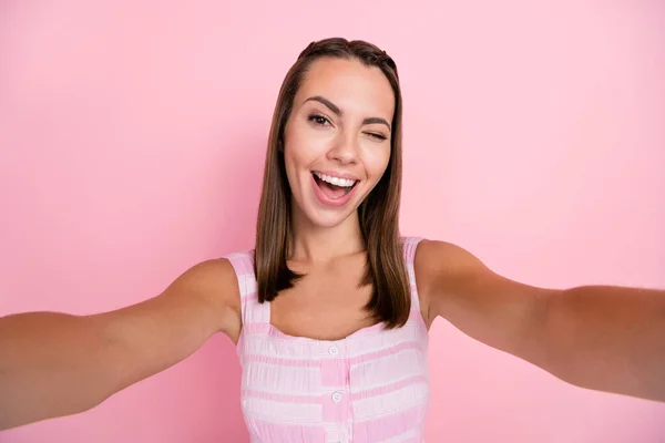 Photo of young cheerful girl playful wink eye flirty make photo camera trip isolated over pink color background — Stock Photo, Image