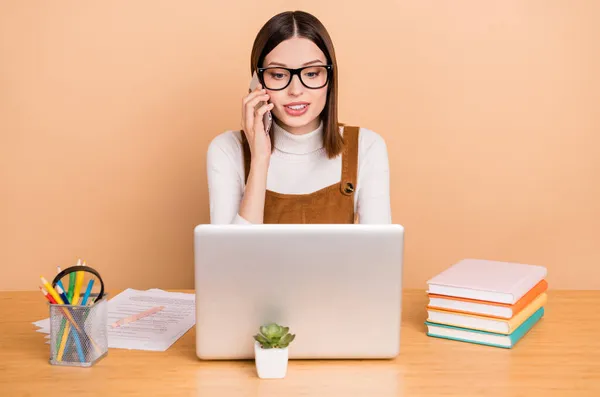 Ritratto di attraente intelligente focalizzata dipendente ragazza utilizzando laptop clienti di consulenza isolati su sfondo di colore beige — Foto Stock