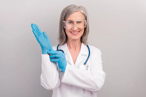 Photo of good mood happy mature lady doctor wear white coat spectacles smiling ready operation isolated grey color background — Stock Photo, Image