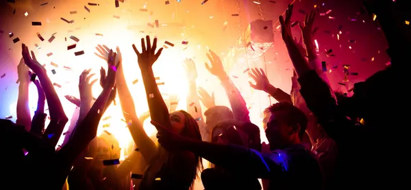 stock image Photo of carefree clubbers blurred movement enjoy electro star performance raise hands up festival confetti modern neon filter